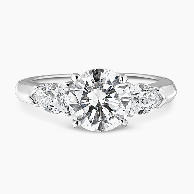 18ct white gold round brilliant cut diamond ring with pear shaped diamonds on the sides