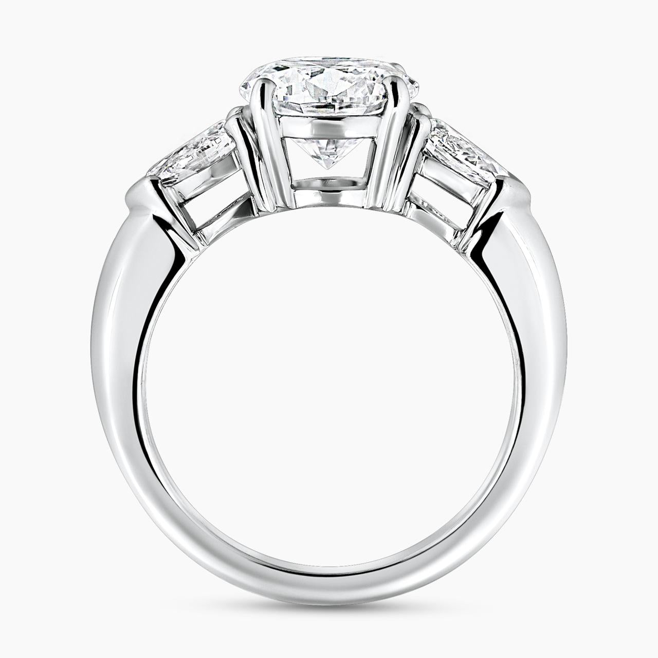 18ct white gold round brilliant cut diamond ring with pear shaped diamonds on the sides side profile view