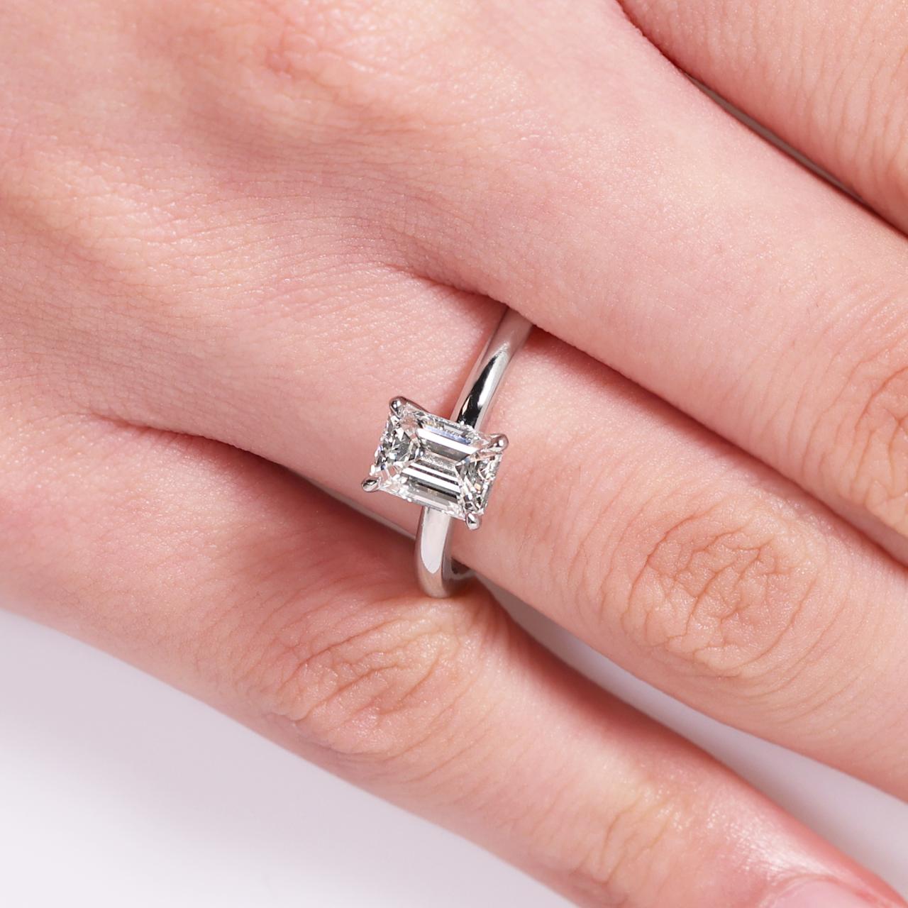 18ct white gold emerald cut diamond solitaire engagement ring in a four claw setting GIA Cert