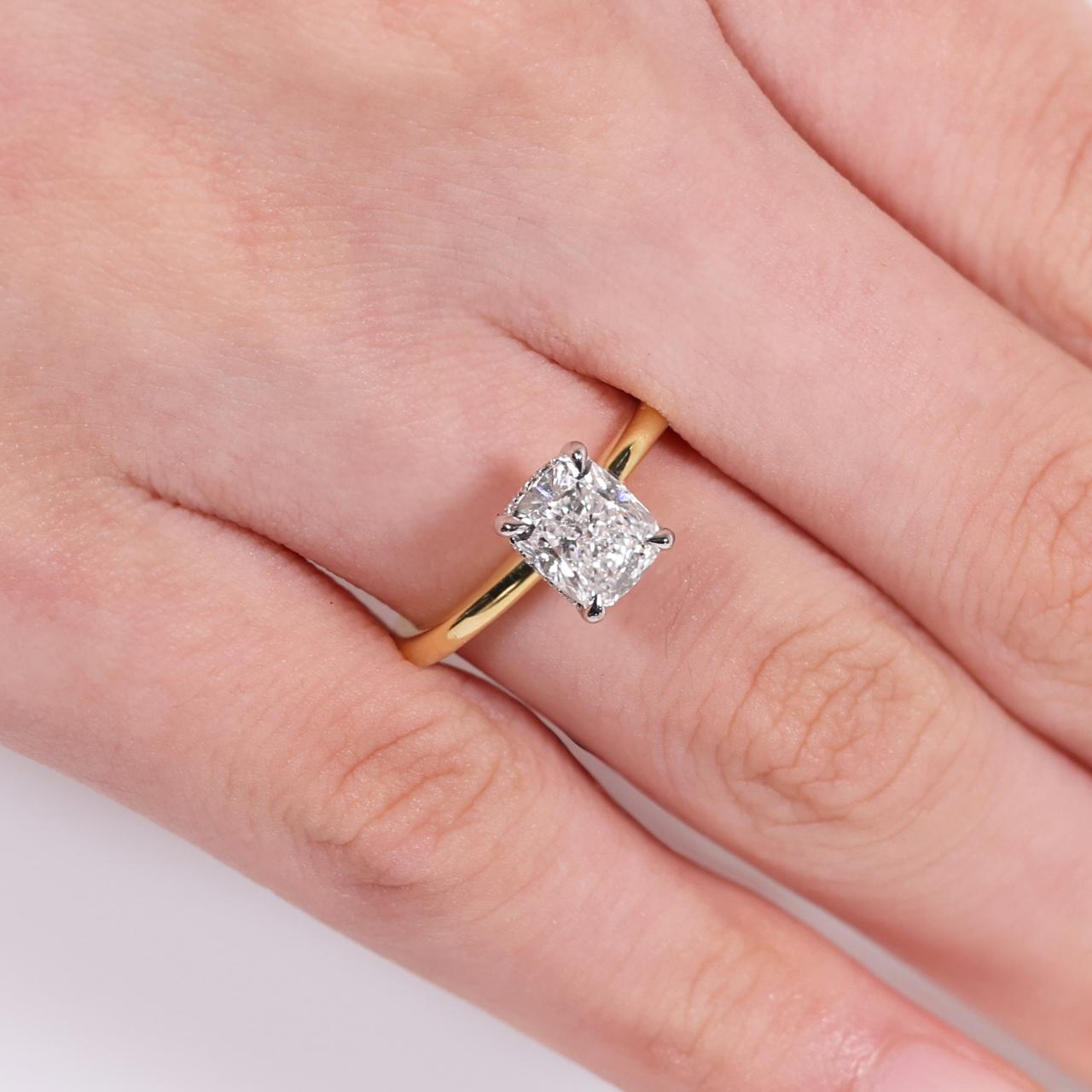 18ct yellow and white gold Cushion cut diamond ring with hidden halo on finger