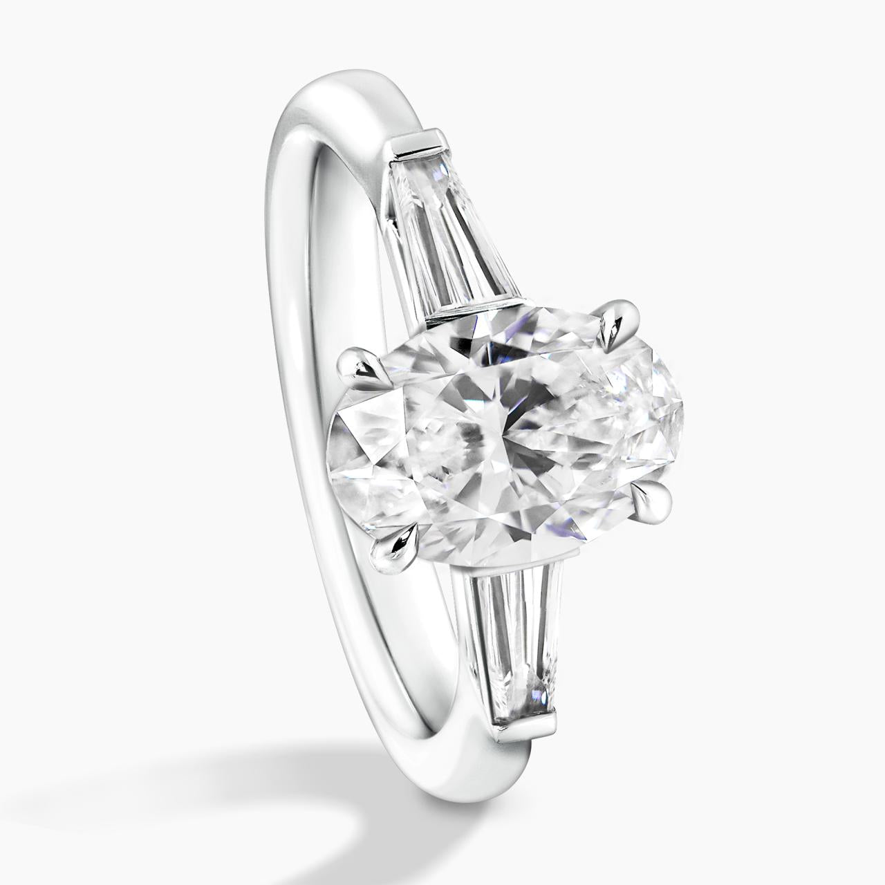 18ct white gold 1.80ct oval brilliant cut diamond ring features 2=0.46ct tapered baguette diamonds 