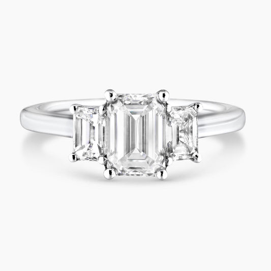 18ct white gold 1.20ct and 2=0.70ct emerald cut diamonds ring in a four claw setting 