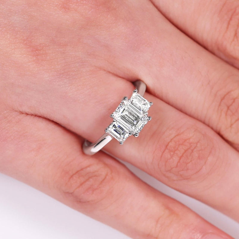 18ct white gold 1.20ct and 2=0.70ct emerald cut diamonds ring in a four claw setting GIA Cert on finger