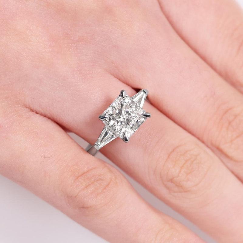 18ct white gold 3.01ct square radiant diamond and 2=0.38ct tapered baguette diamonds ring on finger
