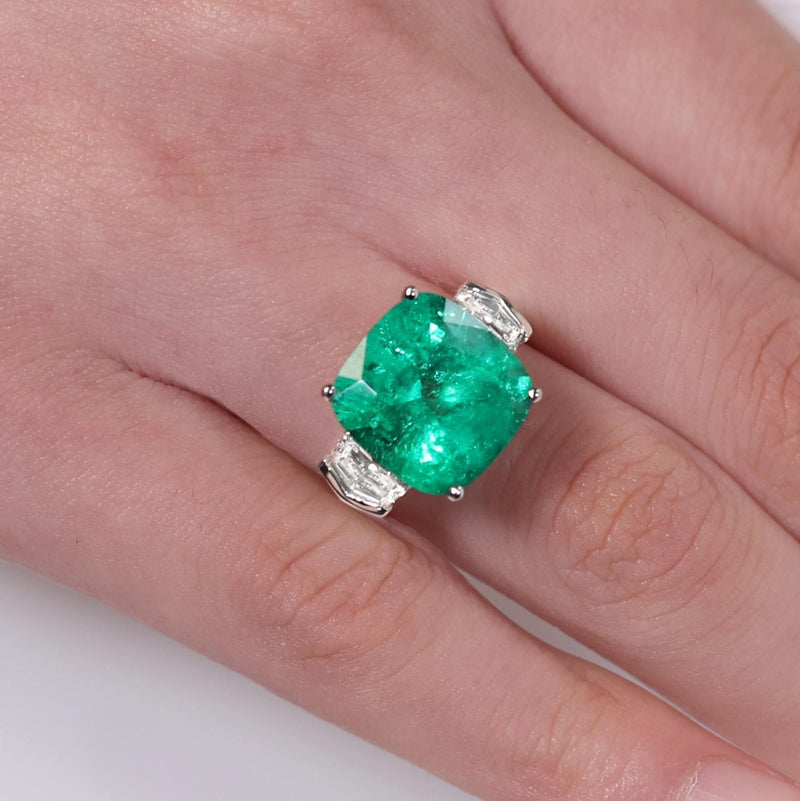 18ct white gold cushion cut Colombian Emerald and Cadillac diamond ring on the finger