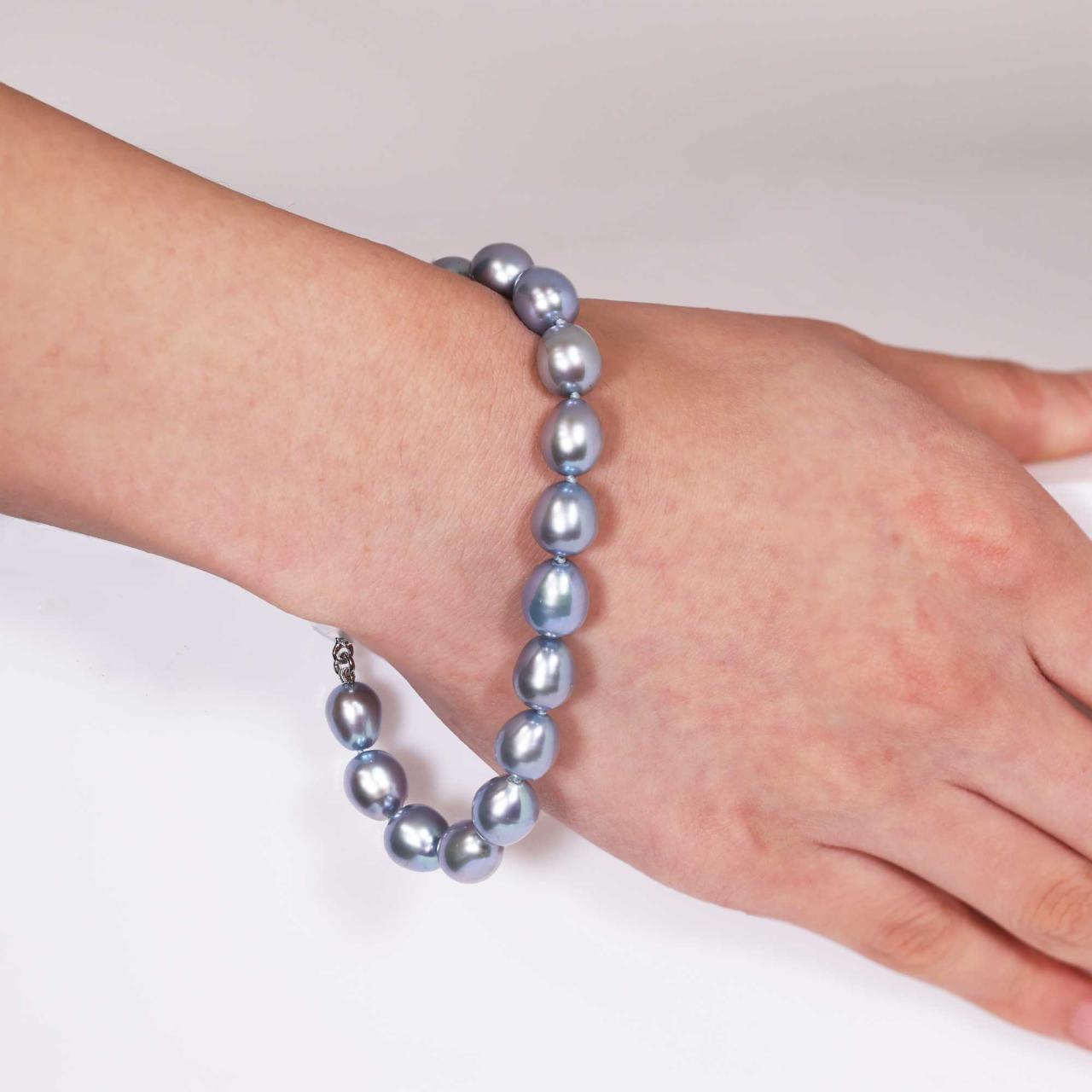 Fresh water dyed pearl bracelet features a silver rhodium plated magnetic ball clasp on the hand