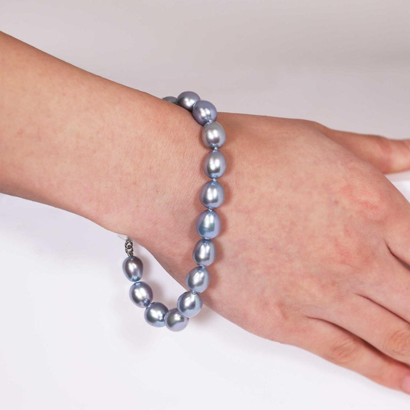 Fresh water dyed pearl bracelet features a silver rhodium plated magnetic ball clasp on the hand