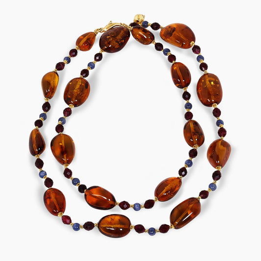 Amber, kyanite and garnet beads necklace with gold-plated silver fittings from the Carmela Cerrone Collection on a white background