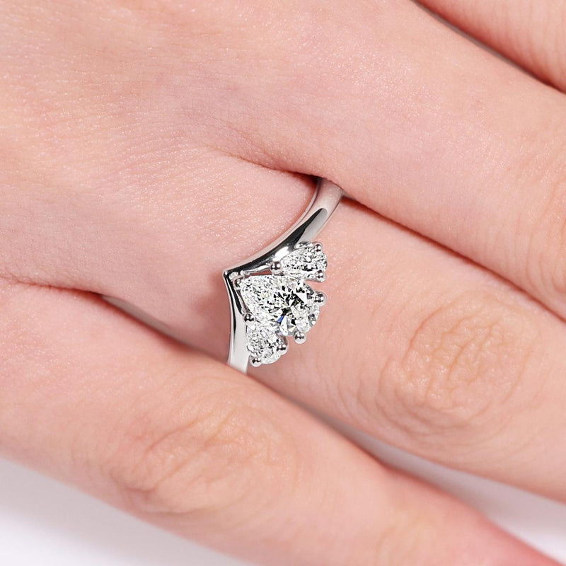 18ct white gold pear shaped diamond engagement ring with pear shaped diamonds on the side on the finger
