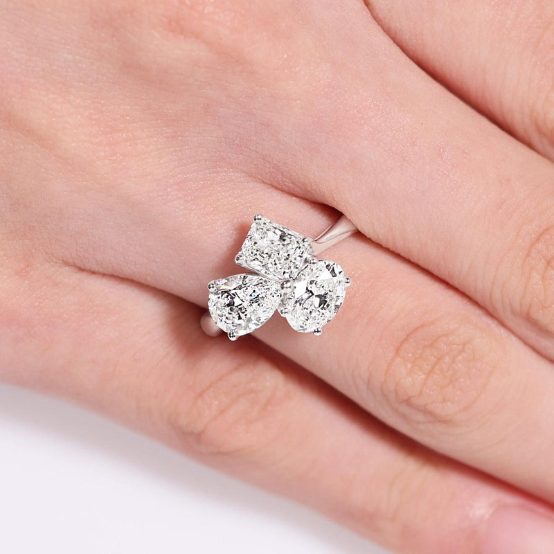 18ct white gold oval, pear and radiant diamond engagement ring on the finger