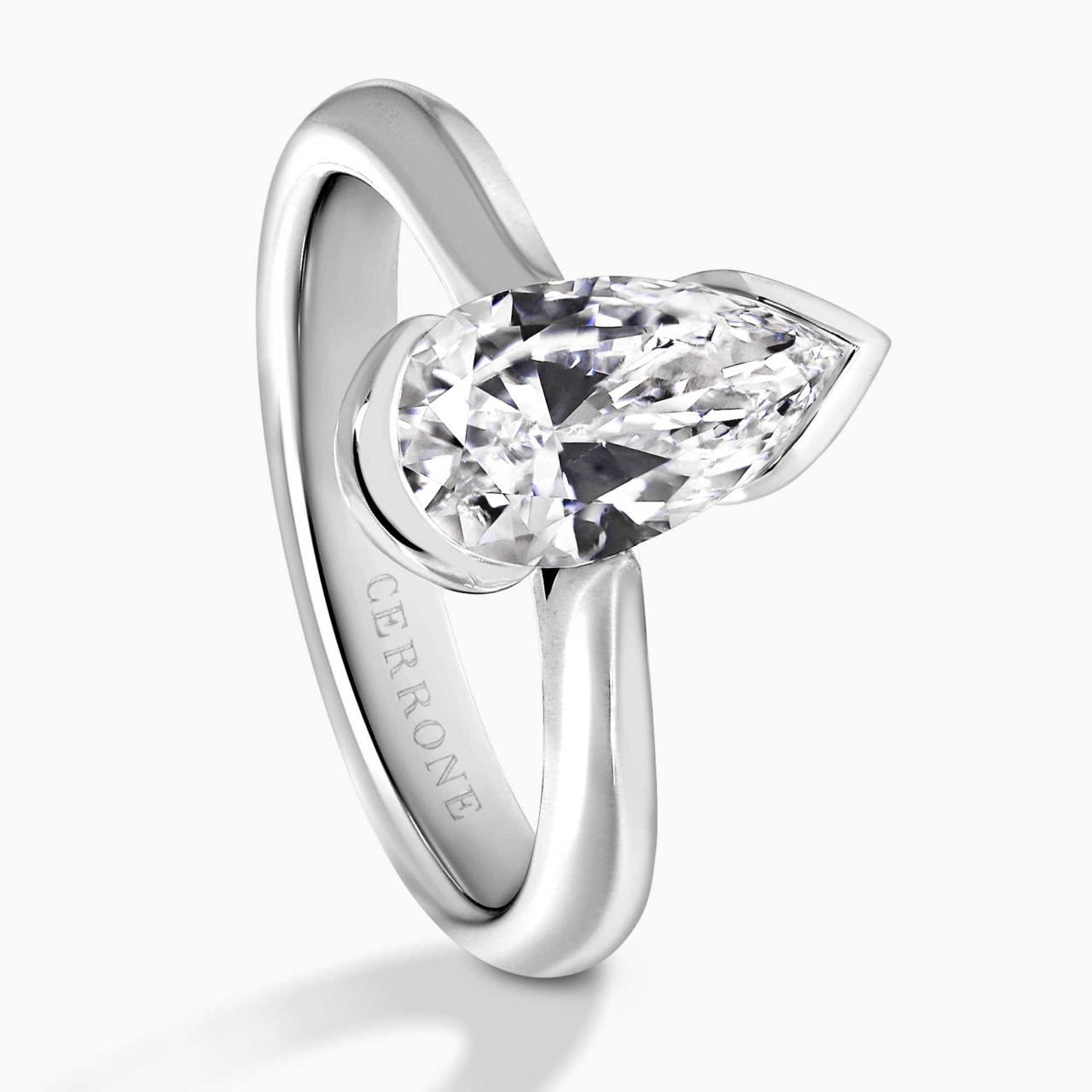 Platinum gold 1.40ct D VVS2 pear shaped lab grown diamond solitaire engagement ring in a half bezel setting. IGI Cert