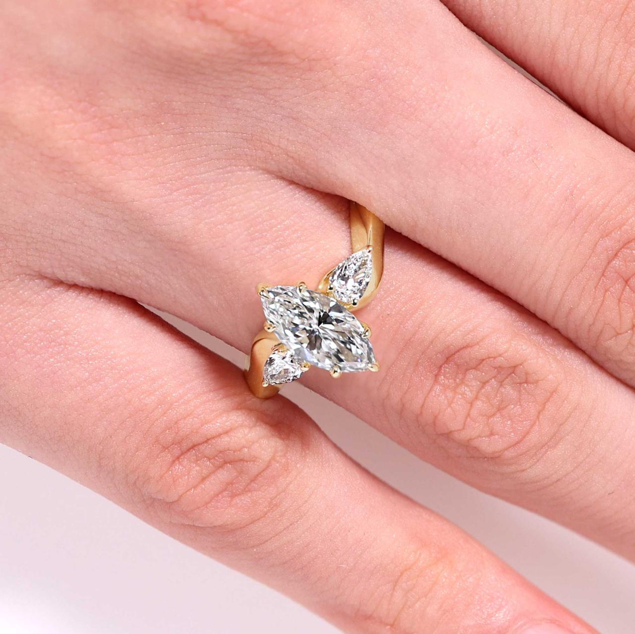 18ct yellow gold 1.27ct D VVS2 marquise lab grown diamond engagement ring with pear shaped lab diamonds on the side IGI Cert