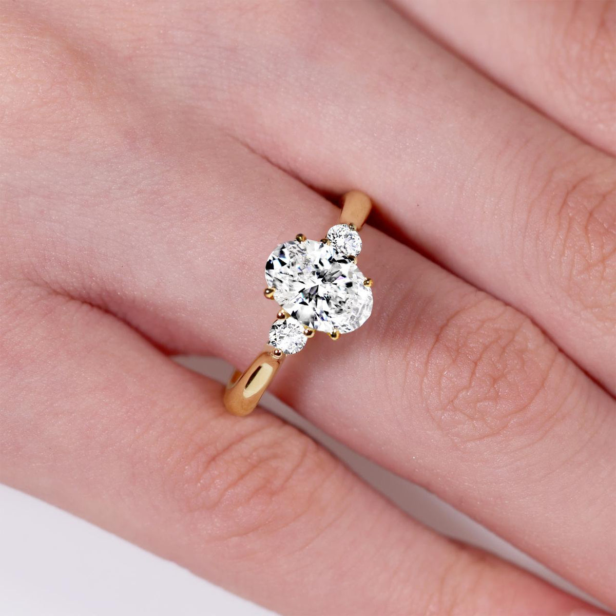 18ct yellow gold 1.60ct and 2=0.10ct oval lab grown diamonds three stone ring