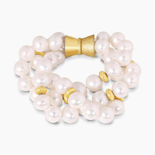 Three rows of fresh water pearls bracelet with 18ct yellow gold rondels ended with a gold plated magnetic clasp from the Carmela Cerrone Collection on a white background