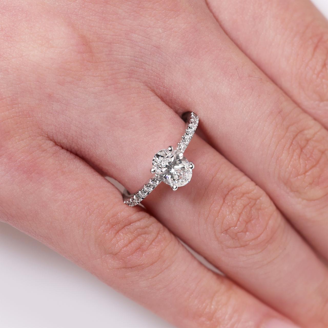 PORTOFINO - 4 CLAW 18ct white gold oval brilliant cut diamond ring with diamond band. GIA Cert
