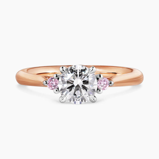 18ct white and rose gold round brilliant cut diamond engagement ring with round pink diamonds on either side