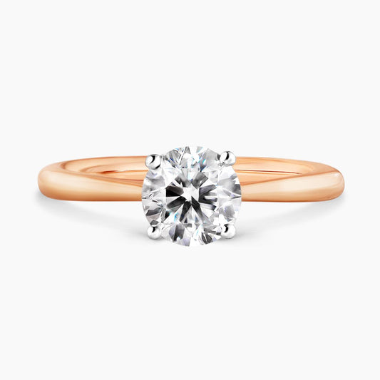 PUGLIA - 18ct rose gold round brilliant cut diamond solitaire engagement ring in a four claw setting with hidden halo