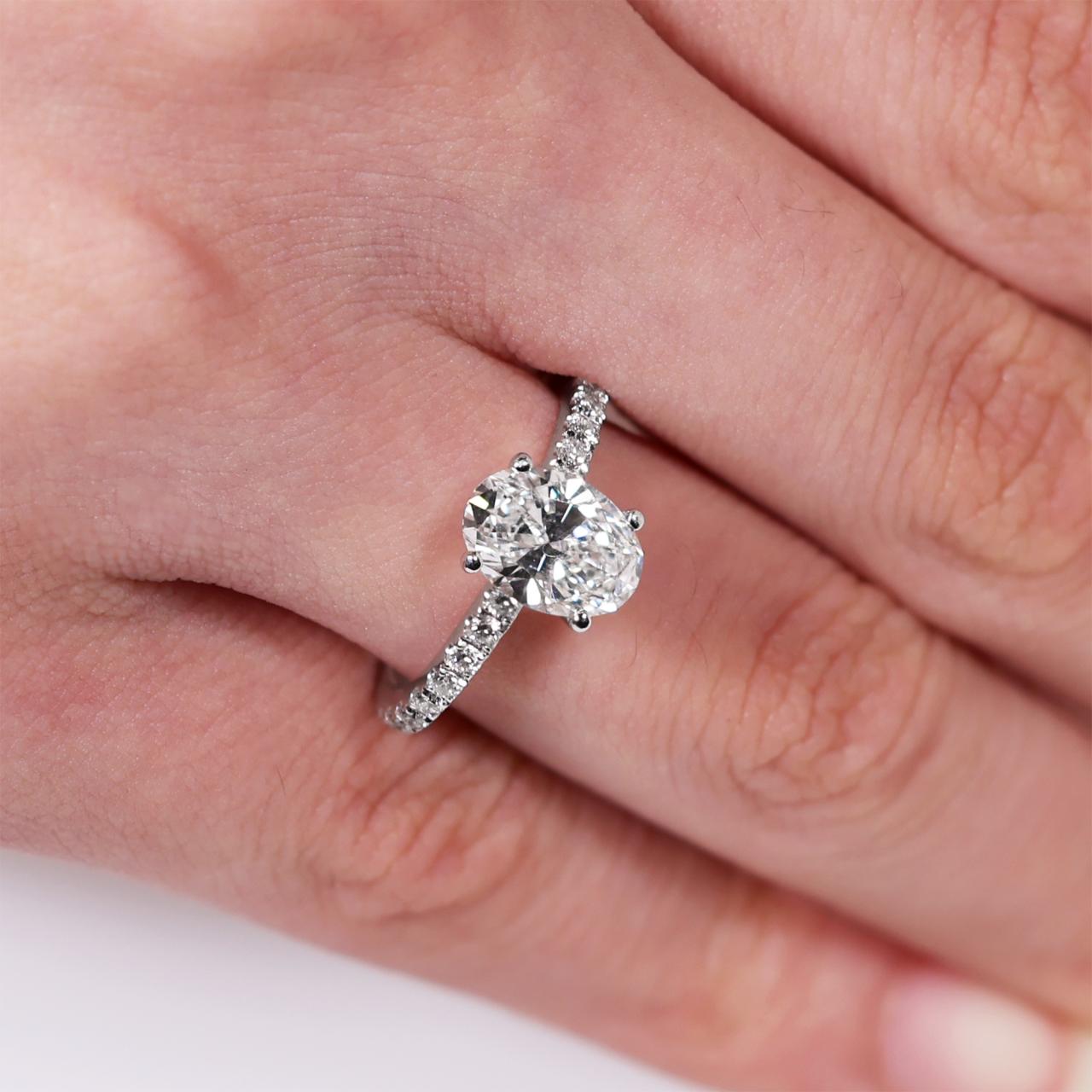 18ct white gold oval cut diamond engagement ring in a four claw setting with a diamond band. GIA Cert