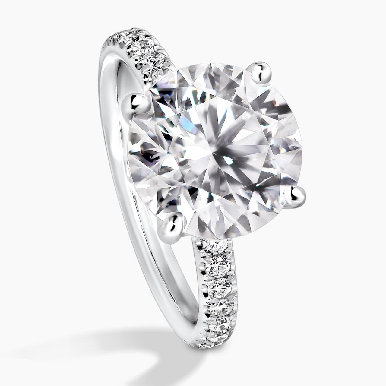 18ct white gold round briliant cut diamond engagement ring in a four claw setting with a hidden halo and diamond band. GIA cert