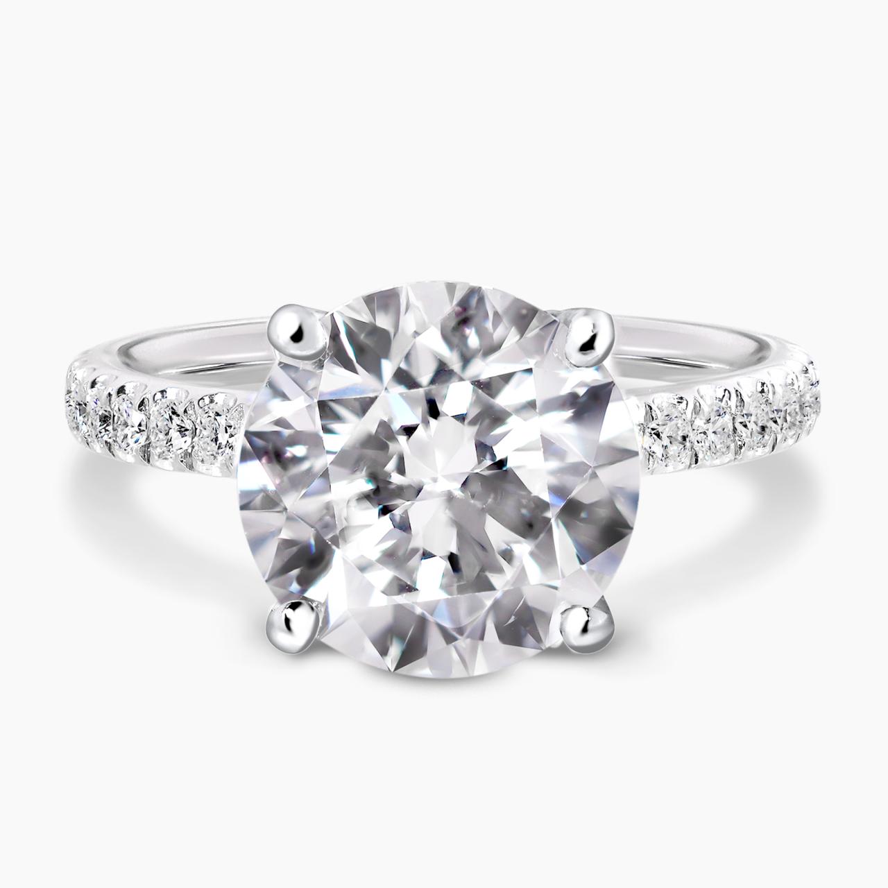 18ct white gold round briliant cut diamond engagement ring in a four claw setting with a hidden halo and diamond band. GIA cert