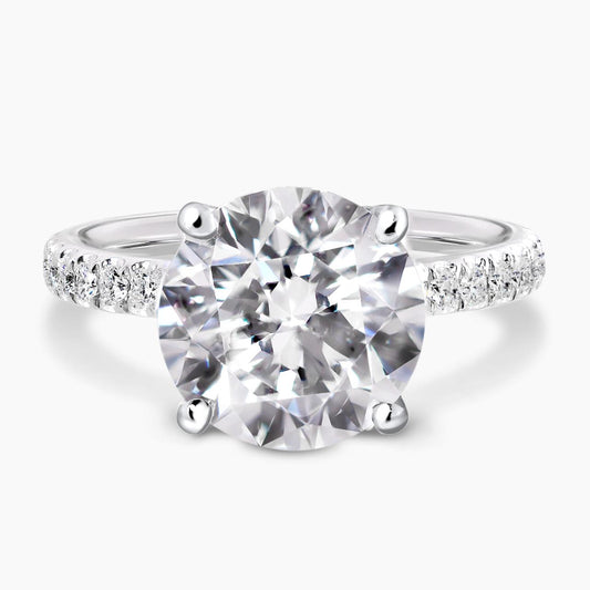 18ct white gold round briliant cut diamond engagement ring in a four claw setting with a hidden halo and diamond band