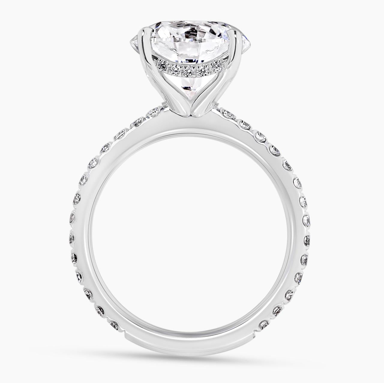 18ct white gold round briliant cut diamond engagement ring in a four claw setting with a hidden halo and diamond band. GIA cert