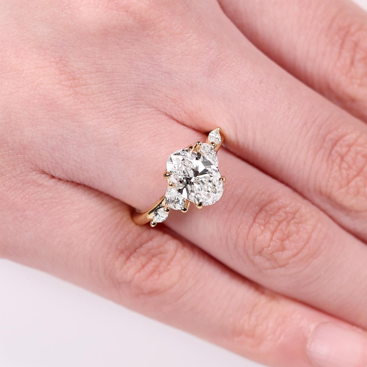 18ct yellow gold 2.00ct D VVS2 oval lab grown diamond ring with pear and marquise shaped lab grown diamonds. IGI Cert
