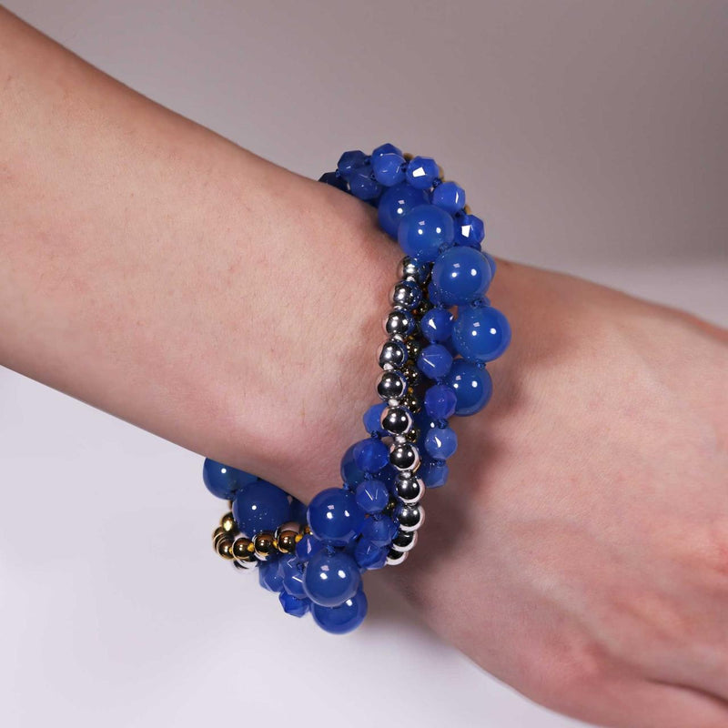 Three rows of blue agate, single row of silver plate hemitite and single row of gold plated hemitite beads bracelet ended with a silver magnetic clasp on the wrist