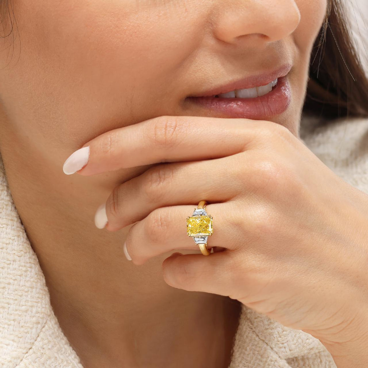 AURELIA 18ct yellow gold 3.02ct FVY VS1 radiant lab grown diamond ring with trapezoid lab grown diamonds on the side on the finger