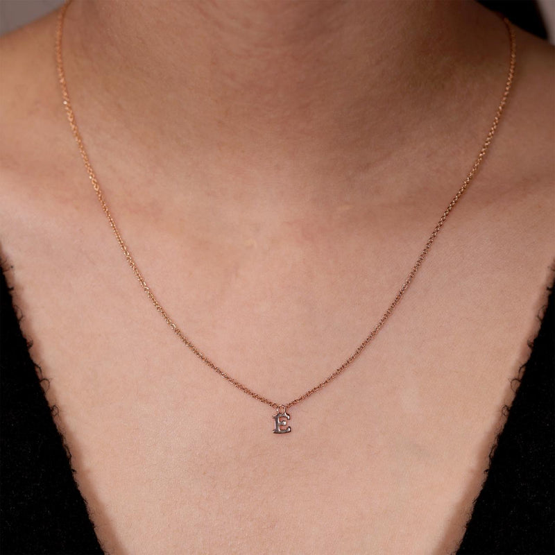 18ct rose gold initial "E" necklace on the neck