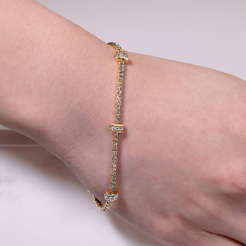 18ct yellow gold round brilliant cut diamond tennis bracelet on the wrist