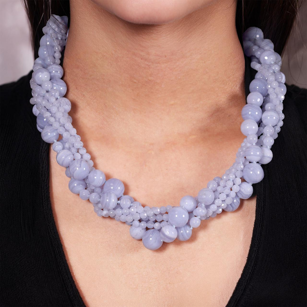 Six rows of blue lace agate beads necklace ended with a silver magnetic clasp on the neck