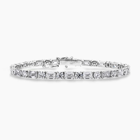 18ct white gold emerald and round brilliant cut diamonds tennis bracelet in a four claw setting