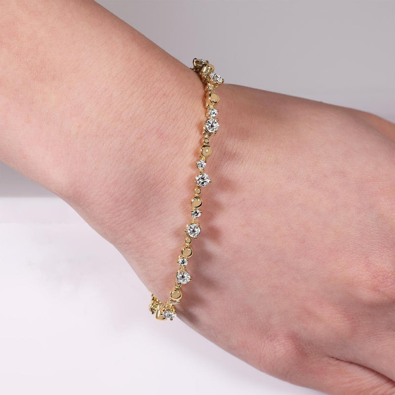 18ct yellow gold 16=1.96ct DEF VVS VS round brilliant cut Lab grown diamonds tennis bracelet in a three claw setting on the wrist