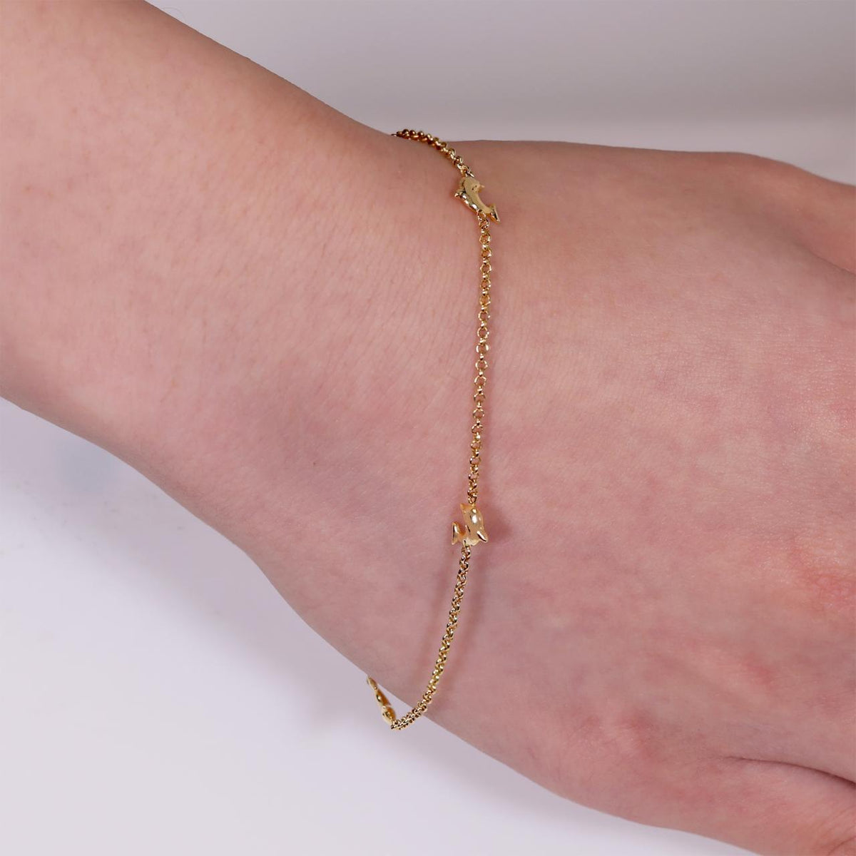 18ct Yellow Gold small Dolphins Bracelet on the wrist