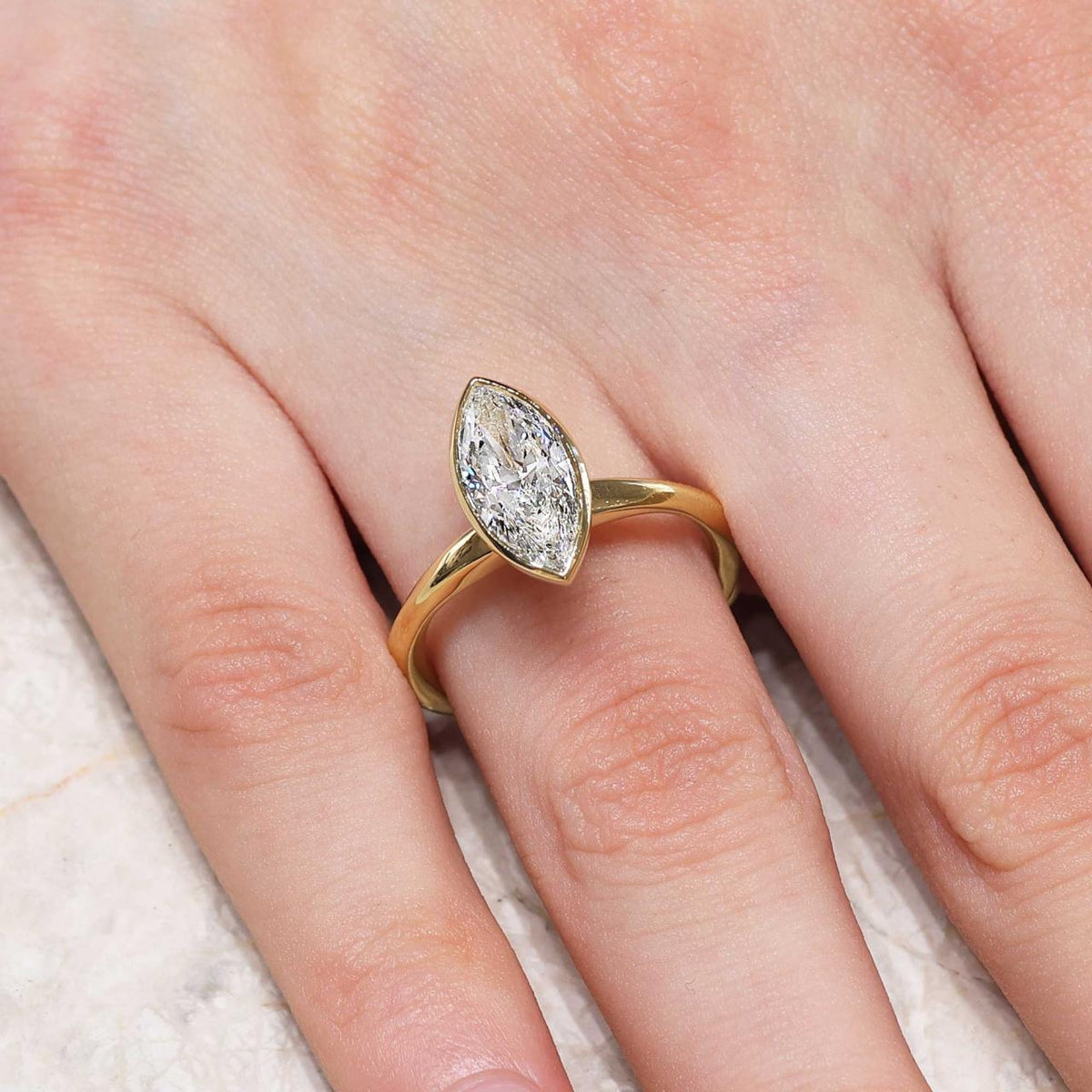 18ct yellow gold 1.75ct E VVS2 lab grown marquise diamond solitaire ring in a bezel setting IGI Cert