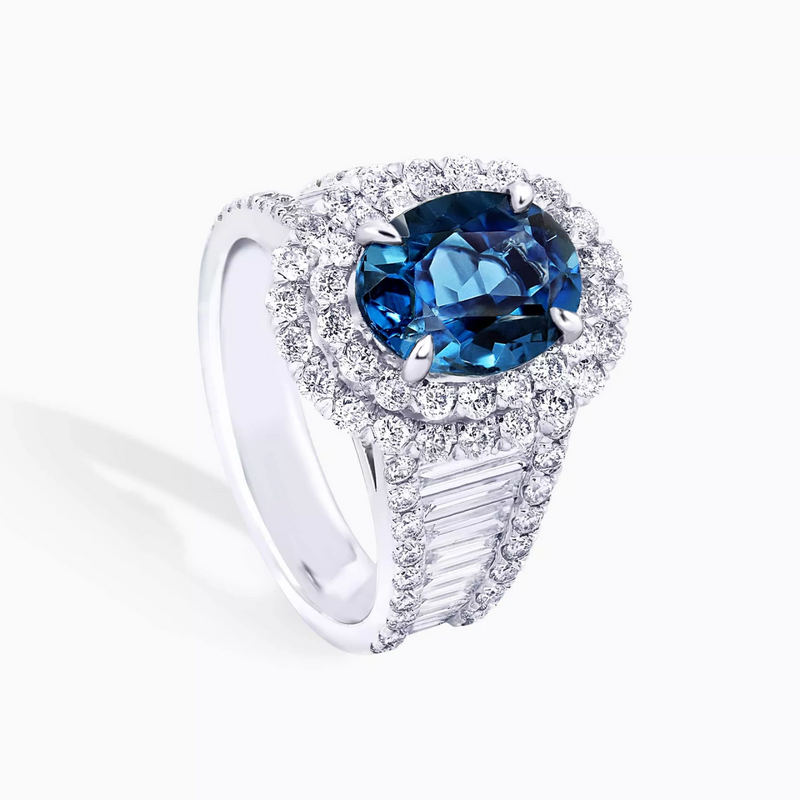 Platinum oval London blue topaz, baguette and round brilliant cut diamond double halo ring side view