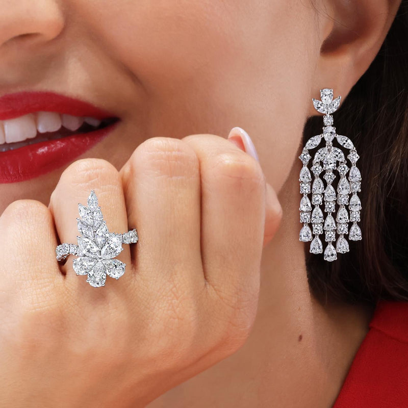 Platinum pear marquise and round brilliant cut diamond cluster ring on the finger