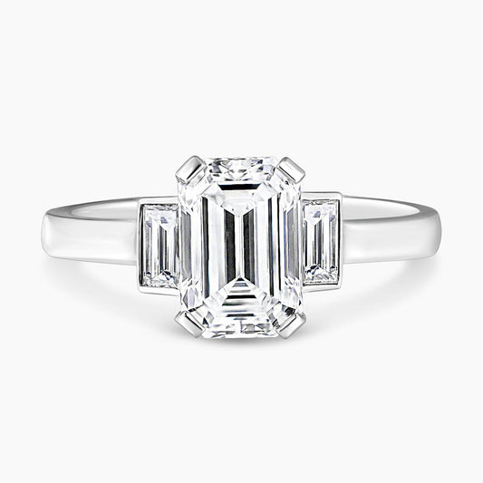 Platinum 1.81ct emerald cut diamond ring with baguette diamonds in bezel setting on the side