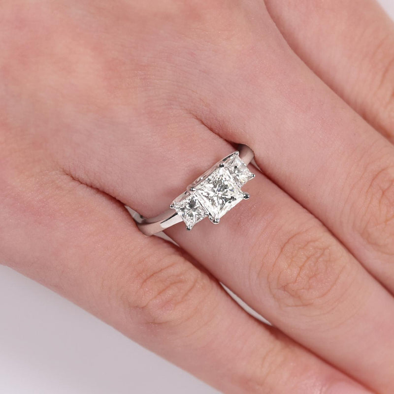 18ct White Gold 3 stone Engagement ring featuring a 1.02ct Princess Cut Diamond in the centre and Princess Cut Diamonds on either side on finger