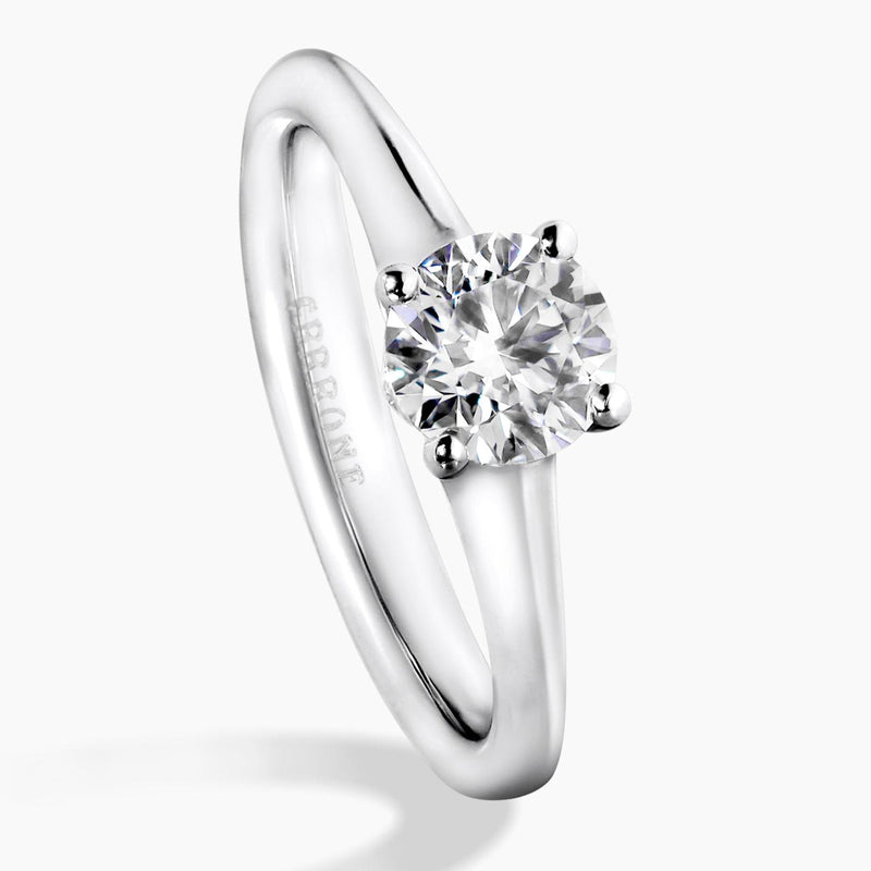 Platinum and rose gold round brilliant cut diamond engagement ring featuring pink round brilliant cut diamonds on the side