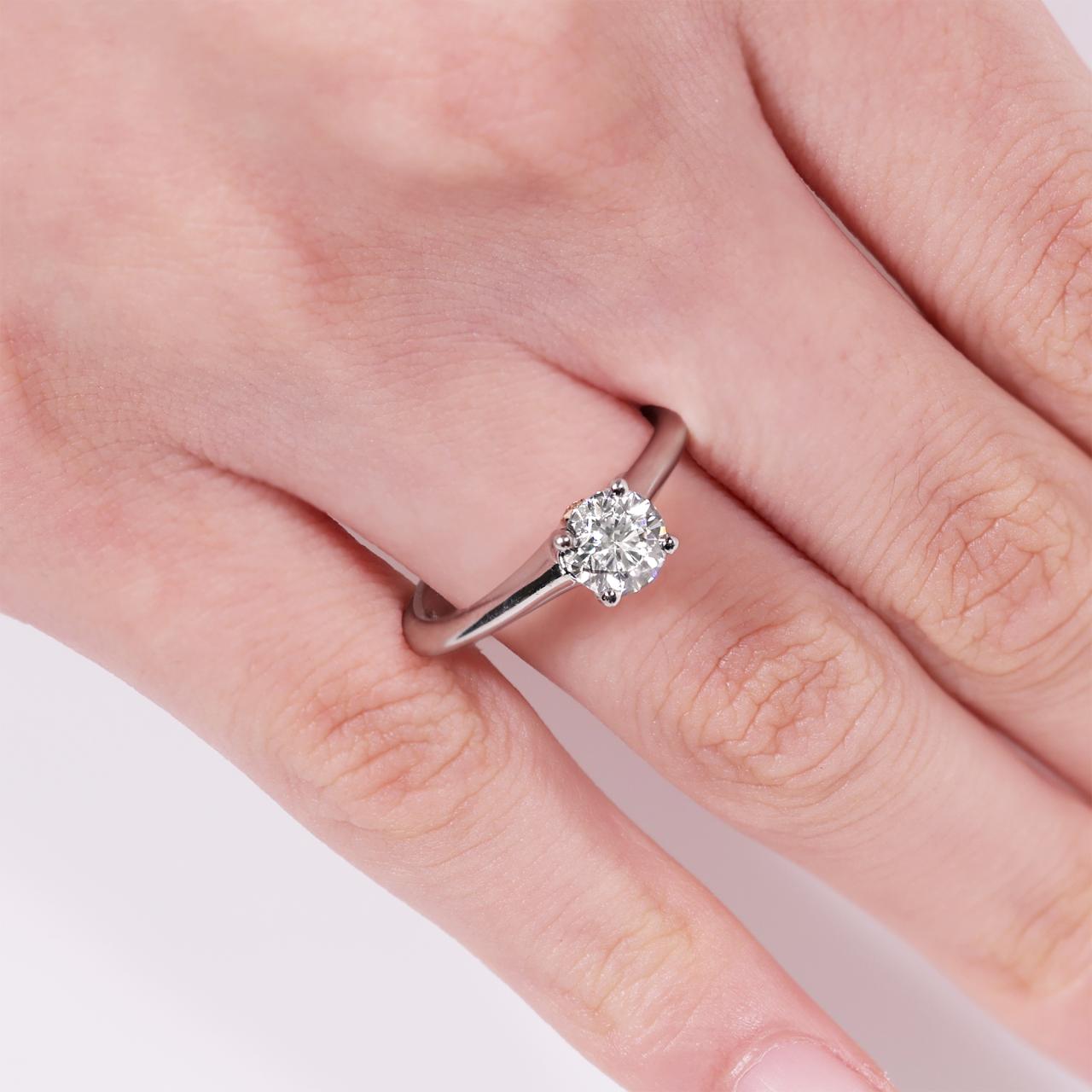Platinum and rose gold round brilliant cut diamond engagement ring featuring pink round brilliant cut diamonds on the finger