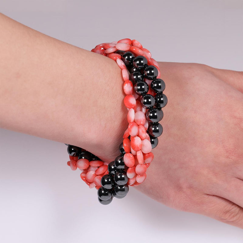 Coral and hemitite bracelet with a silver ribbed magnetic clasp from the Carmela Cerrone Collection on wrist