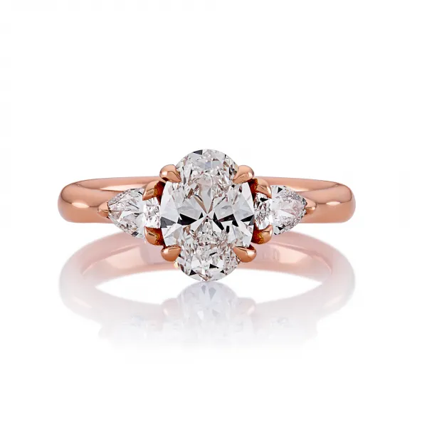18ct rose gold oval diamond ring with pear shaped diamonds in a claw setting