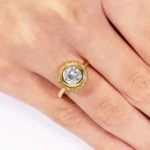 18ct yellow gold round bezel diamond ring with yellow diamond halo