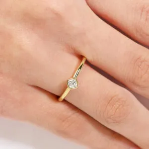 18ct yellow gold 0.19ct FG VS cushion cut diamond solitaire bezel ring